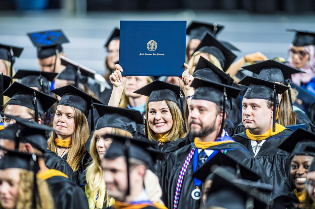MTSU graduates celebrating commencement after completing their degrees.