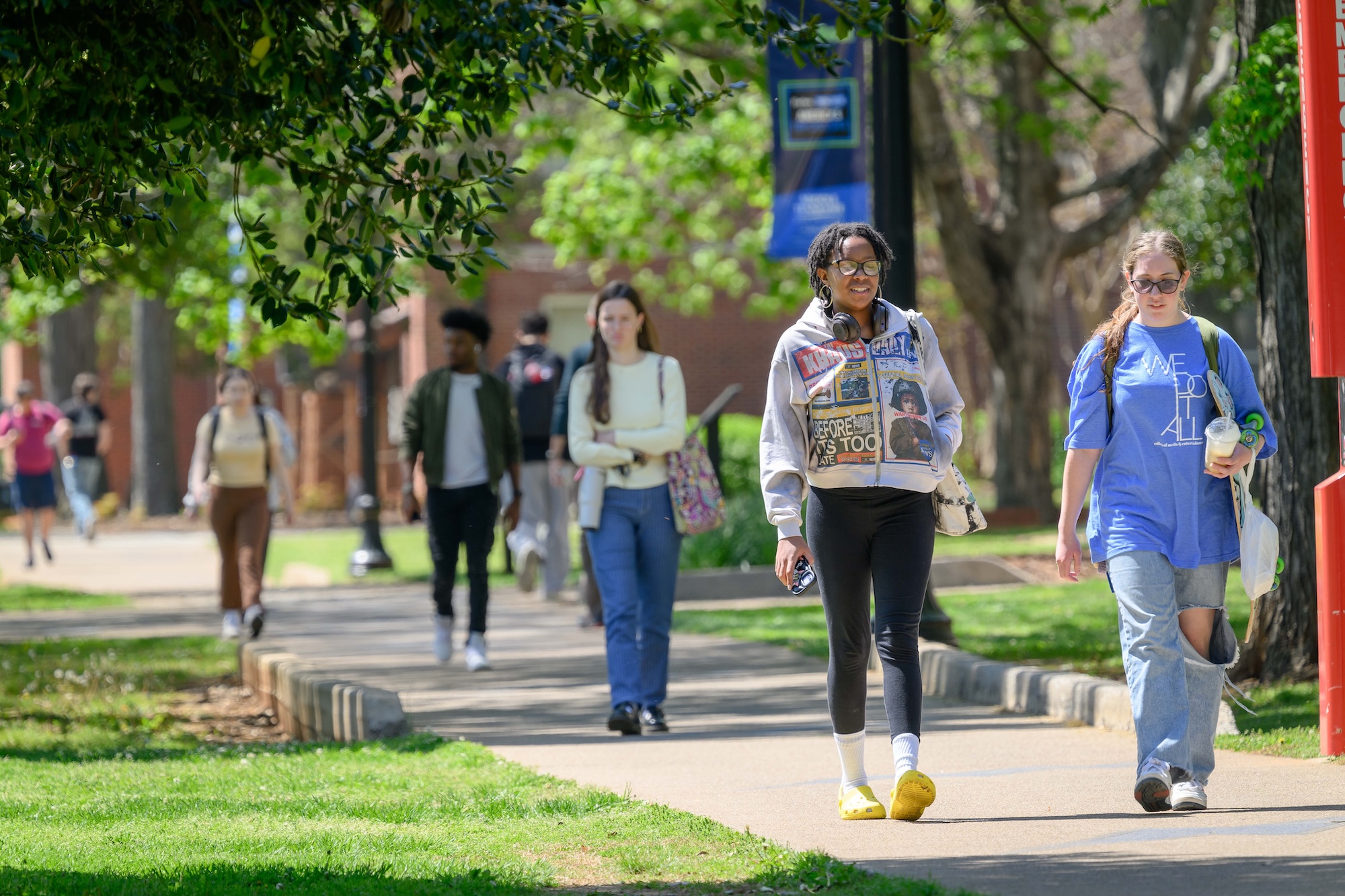 Students walking on campus on a sunny day