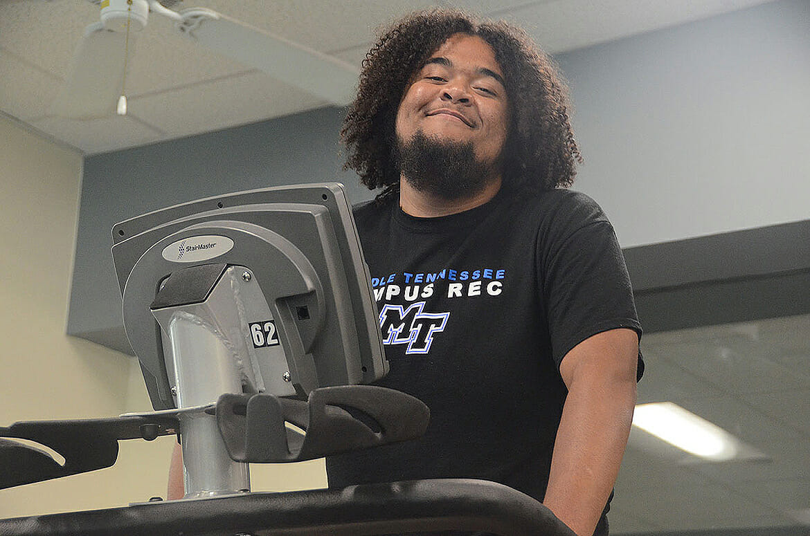 Caleb King working out on a StairMaster