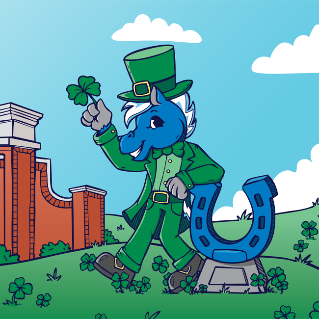 The sky is beautiful and blue as "lucky" Lightning holds up a four leaf clover while leaning against the Blue Horseshoe in a field of clovers.