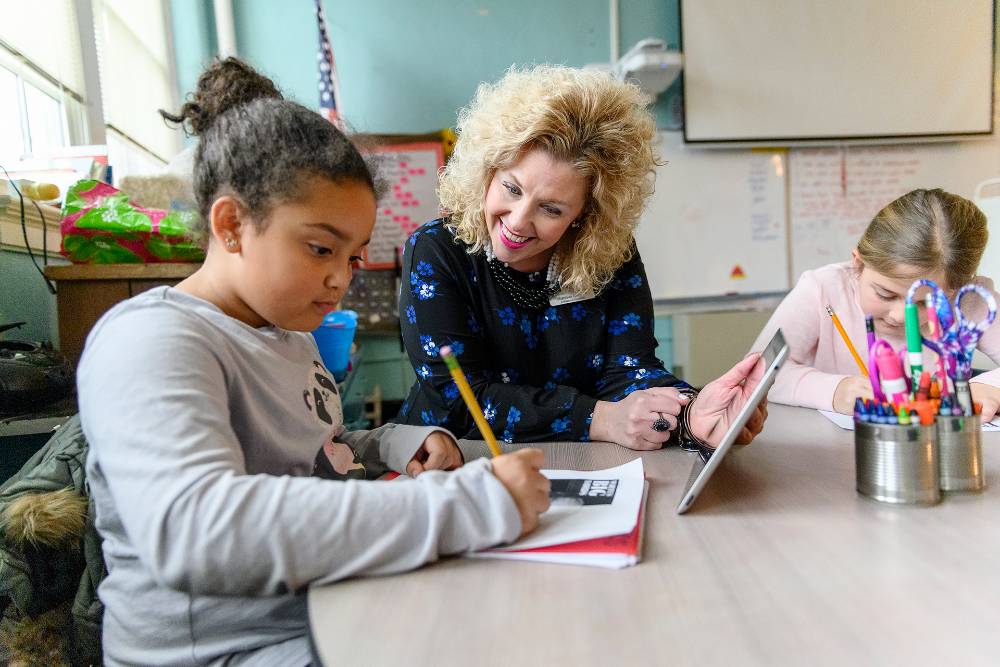 teacher helping student