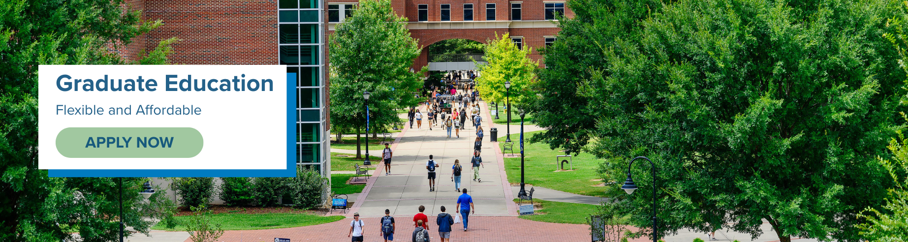 Students walk along a tree-lined campus walkway between brick university buildings on a sunny day, with an overlay text reading 'Graduate Education — Flexible and Affordable' and an 'Apply Now' button.