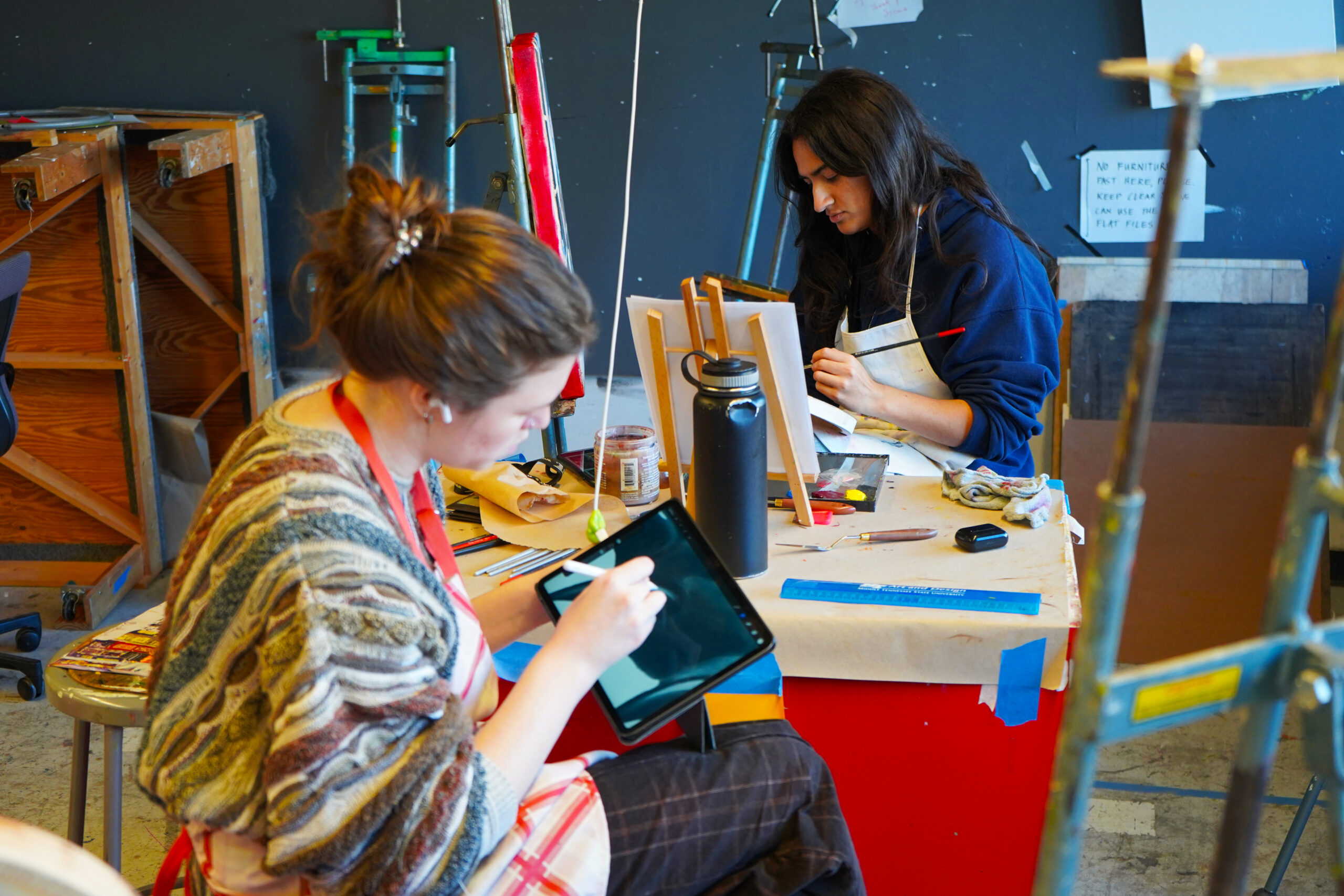 Two art students working on art projects 