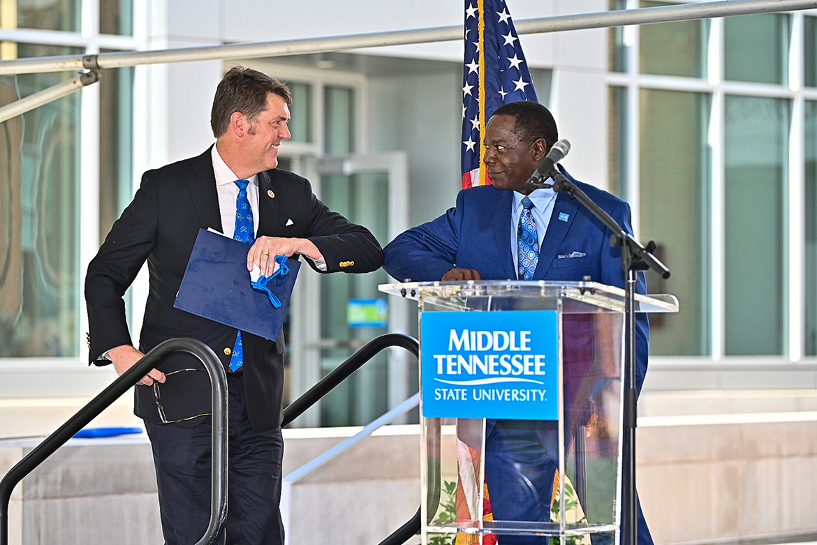 State Sen. Shane Reeves, left, and MTSU President Sidney A. McPhee share an elbow bump prior to Reeves' address to the audience at the Aug. 18 ribbon-cutting for the university's new Academic Classroom Building. (MTSU photo by J. Intintoli)