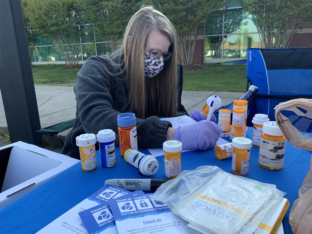 Lipscomb University College of Pharmacy second-year student Kaitlyn Monsue of Dickson, Tenn., documents some of the prescription medications turned in by the public for the spring MTSU Drug Take-Back Day event Thursday, April 22, outside the Health, Wellness and Recreation Center on Blue Raider Drive. Nearly 72 pounds was collected by the end of the 5-plus hour drive to gather old and unwanted medications. (MTSU photo by Randy Weiler)