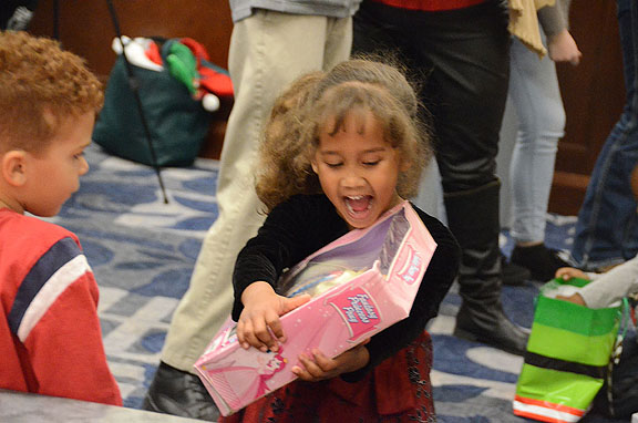 An elated MTSU Little Raider admires her doll from Santa at the recent Christmas celebration for the annual gift-giving campaign. (MTSU photo by Jimmy Hart)
