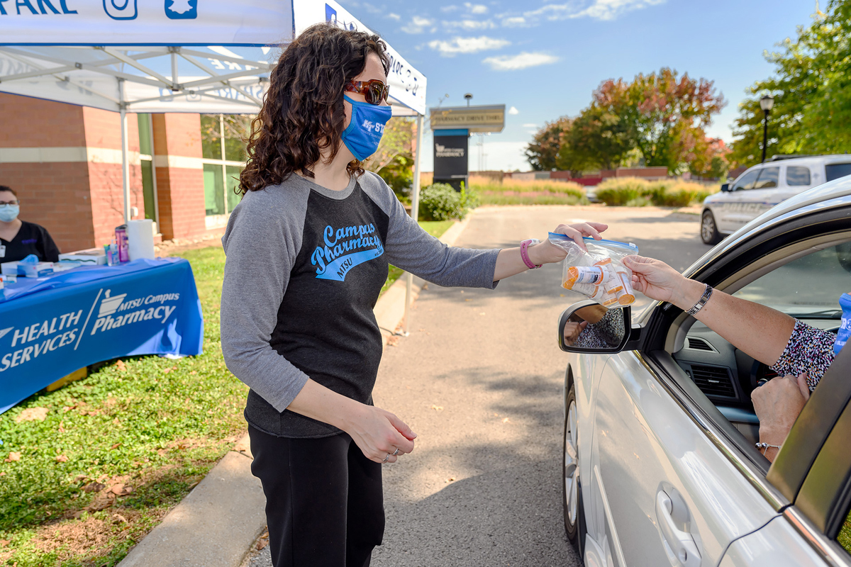 Lisa Schrader, left, MTSU Health Promotion director, receives unwanted medications dropped off by Kristin Wells, who works in the Office of Development, in October 2020 during the semiannual MTSU Drug Take Back Day at the pharmacy drive-thru at the Health, Wellness and Recreation Center. (MTSU file photo by J. Intintoli)