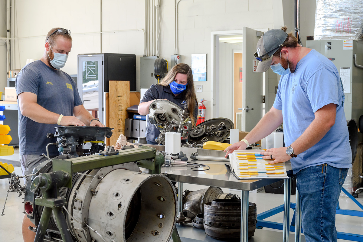 MTSU aerospace maintenance management seniors Brandon Snell, left, Aubrey Vest and Tanner Jones perform training tasks in the Flight Operations Center maintenance hangar at Murfreesboro Airport. They are among five MTSU students who received National Business Aviation Administration Charities scholarships to attend out-of-state training for up to two weeks during the 2020-21 academic year. (MTSU photo by J. Intintoli)