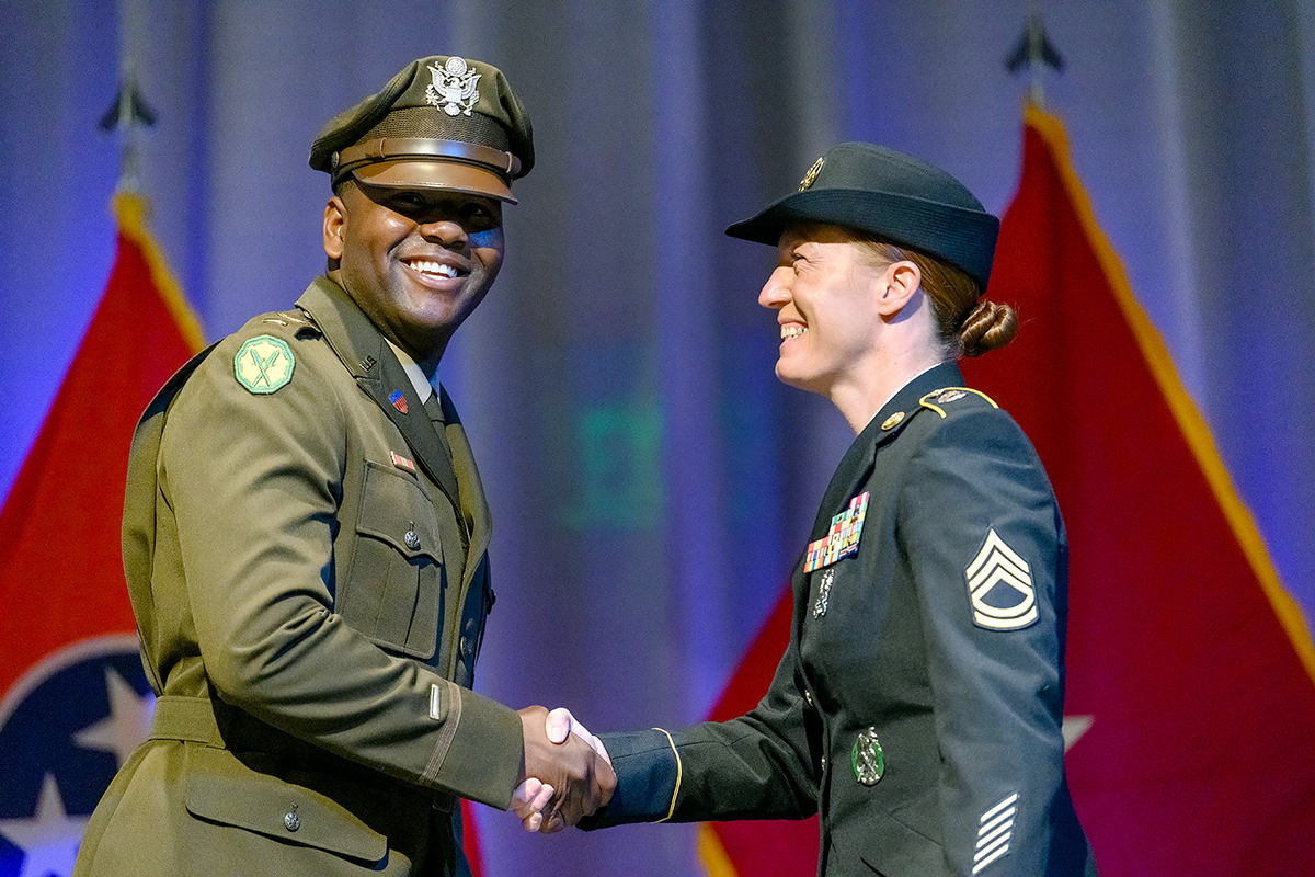 Newly commissioned U.S. Army 2nd Lt. Arne Fisher, left, receives his First Salute and gives a silver dollar to Sgt. 1st Class Kathryn Rayburn during the MTSU Blue Raider Battalion Spring Commission Ceremony Friday, May 7, in the Student Union Ballroom. An Army tradition, newly commissioned second lieutenants hand a silver dollar to the first enlisted soldier who salutes them. (MTSU photo by J. Intintoli)
