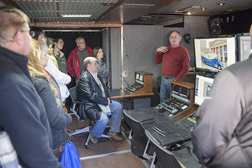 Marc Parrish, standing at right, director of technical systems for MTSU's College of Mass Communication, leads a tour group of prospective students and their parents through the $1.8 million Mobile Production Lab during a 2015 True Blue Experience Day. The college is being renamed as the College of Media and Entertainment. (MTSU file photo by Andy Heidt)