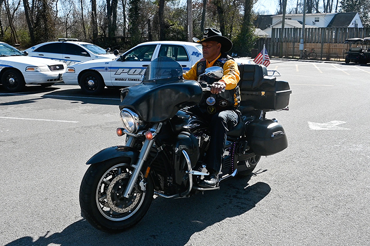Middle Tennessee State University police officer Leroy Carter, a member of the Buffalo Soldiers motorcycle club, rides his 2012 Yamaha V Star 1300 Tourer motorcycle around the police department parking lot on Feb. 5, 2021. (MTSU photo by Stephanie Barrette)