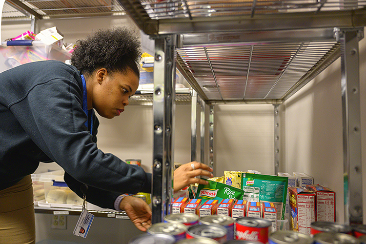 Danielle Rochelle, coordinator of outreach and support programs and supervisor of the MTSU Food Pantry, examines food in the pantry, which will provide food to students from 8 a.m. to 5 p.m. Monday through Friday. (MTSU photo by Cat Curtis Murphy)