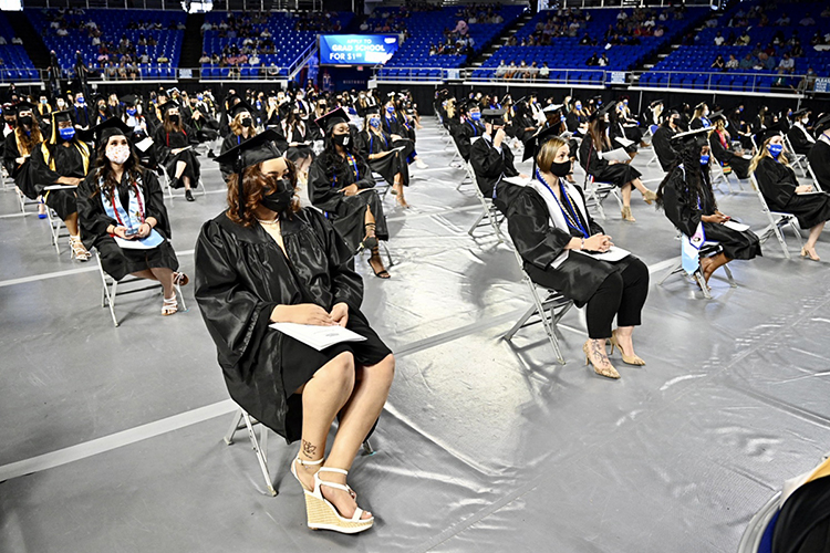 Members of MTSU’s first Class of 2021 sit, masked and 6 feet apart, on the floor of Hale Arena in Murphy Center Friday, May 7, as they prepare to graduate during the first day of the university's spring 2021 commencement ceremonies. Students returned to Murphy Center May 7-9 for the first time since 2019 for a three-day, 10-event, socially distanced commencement weekend. (MTSU photo by J. Intintoli)