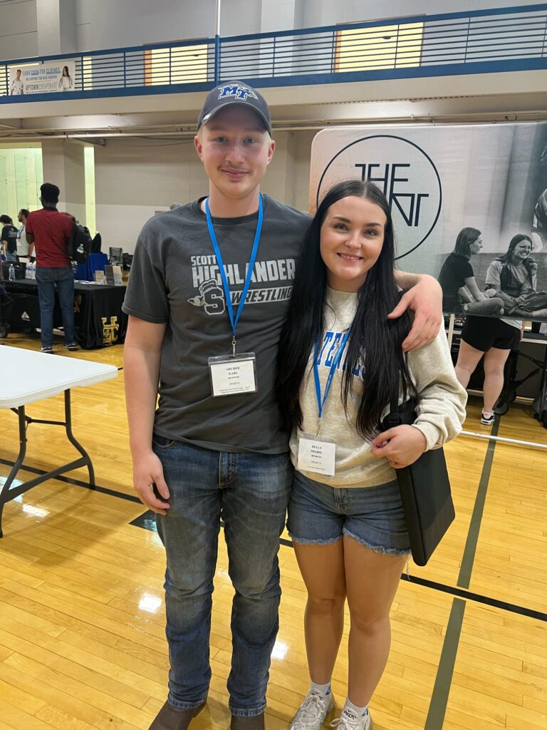 student and parent posing for a photo at an event