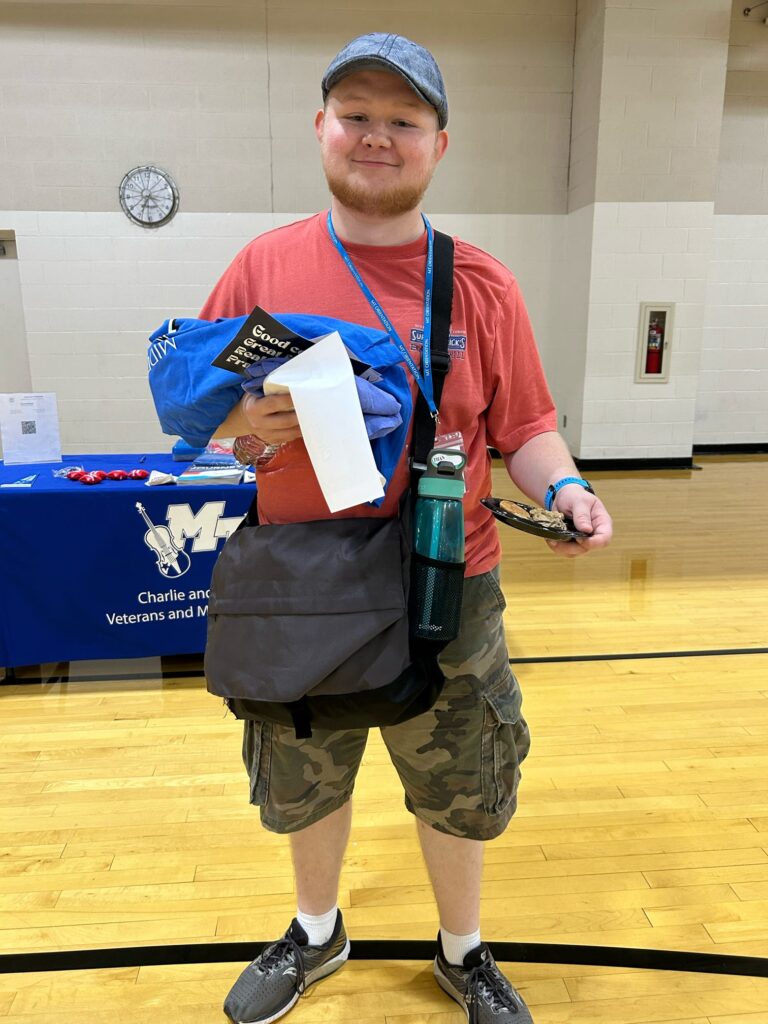 Student smiling for a photo at the campus rec center