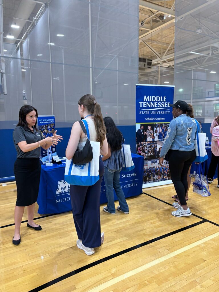 students talking to staff at a tabling event