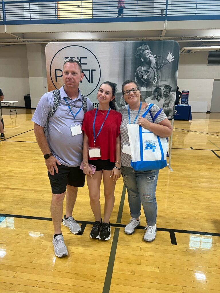 student and parents posing for a photo