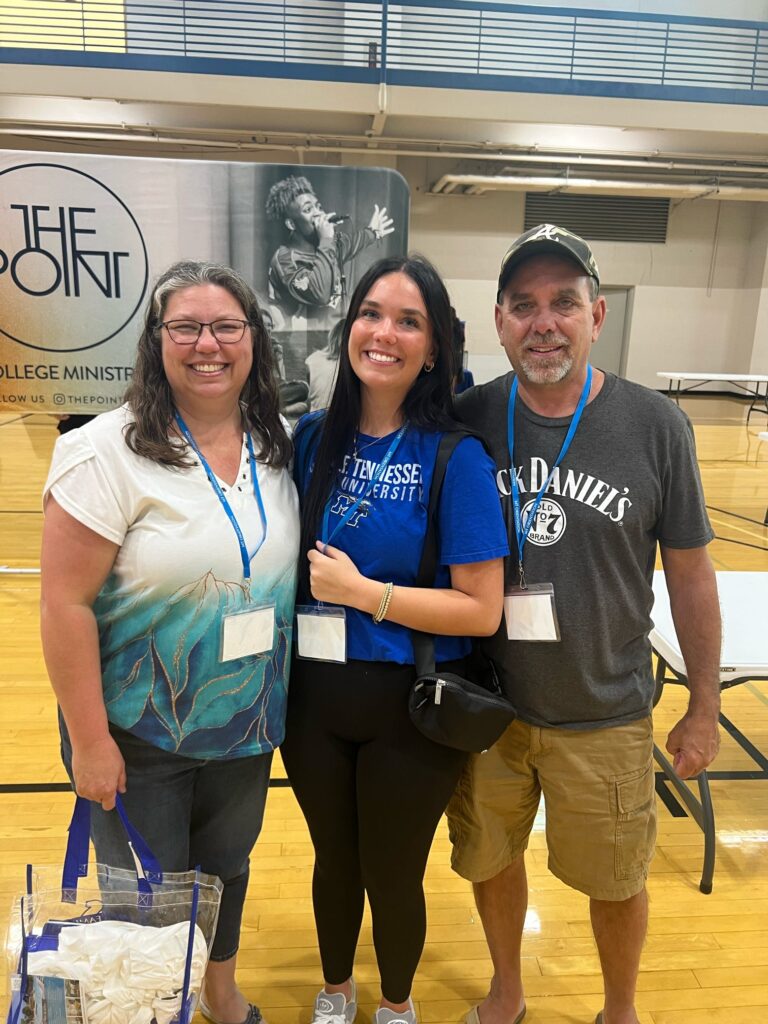 student and parents posing for a photo