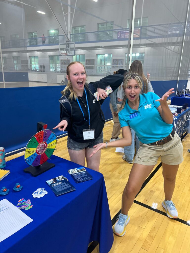 students posing for a photo at a table