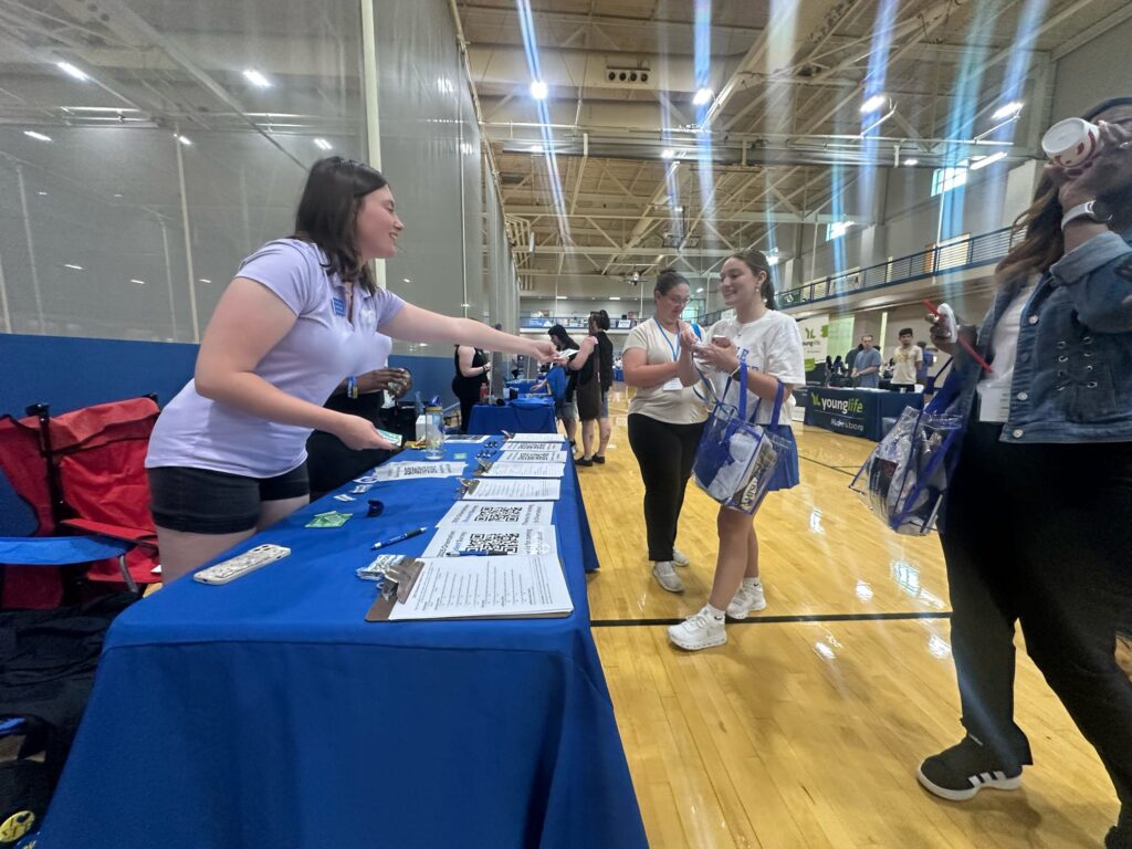 two people talking at a tabling event