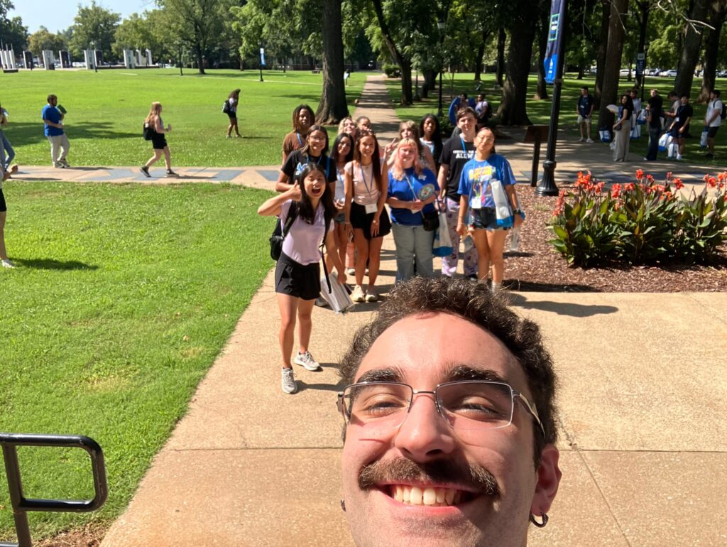 Students taking a selfie with their Student Orientation Assistant on the Raider Walk at Walnut Grove.