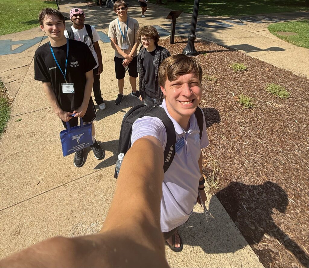 Students taking a selfie with their Student Orientation Assistant on the Raider Walk at Walnut Grove.