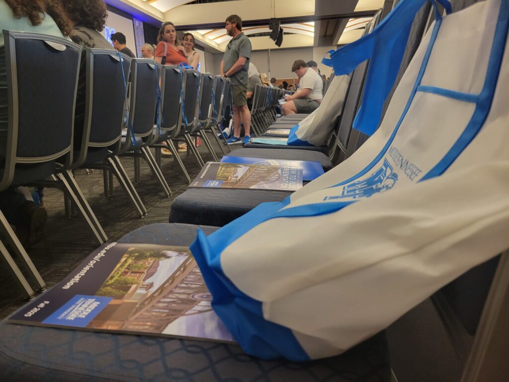 A blue and white MTSU bag placed on a chair in the Student Union where students will soon be after being checked in to orientation.