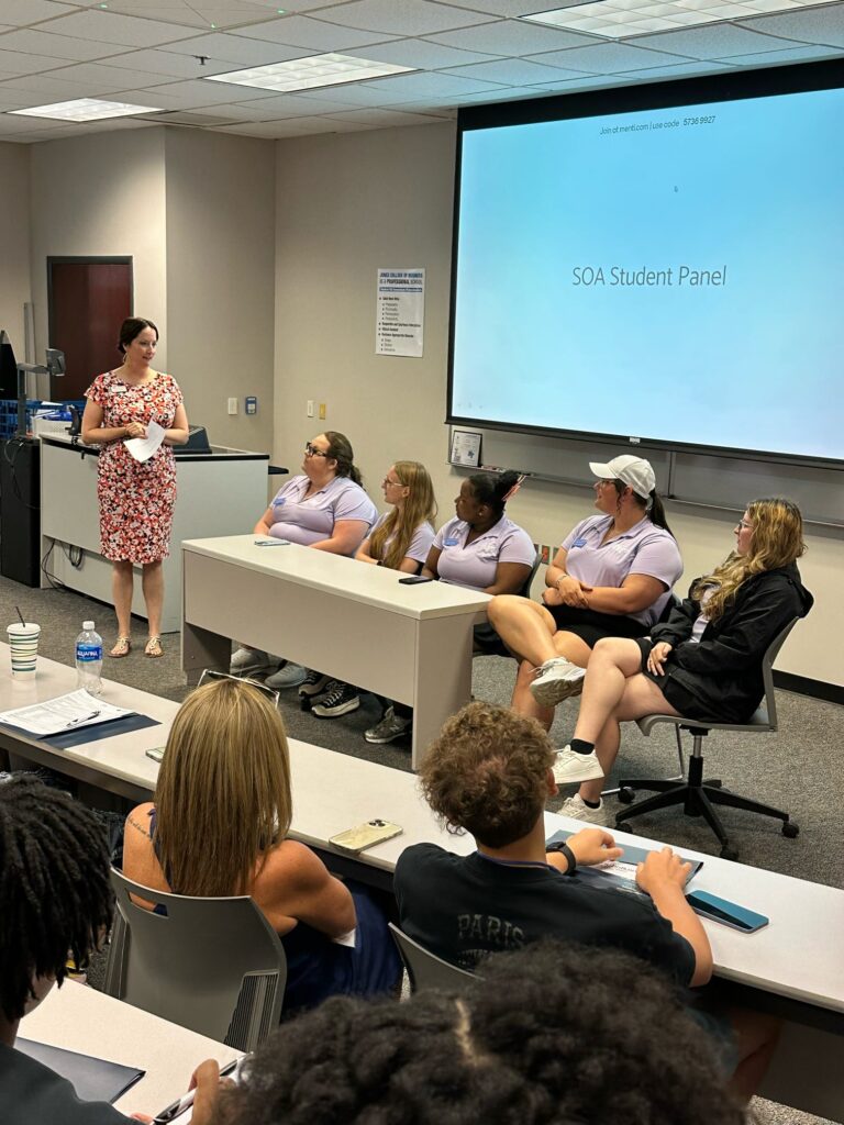 Students sitting and watching a Student Orientation Assistants panel.