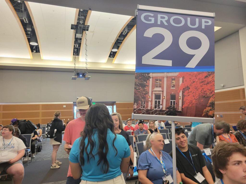 Students checking in to orientation by their Student Orientation Assistant in the Student Union ballroom.