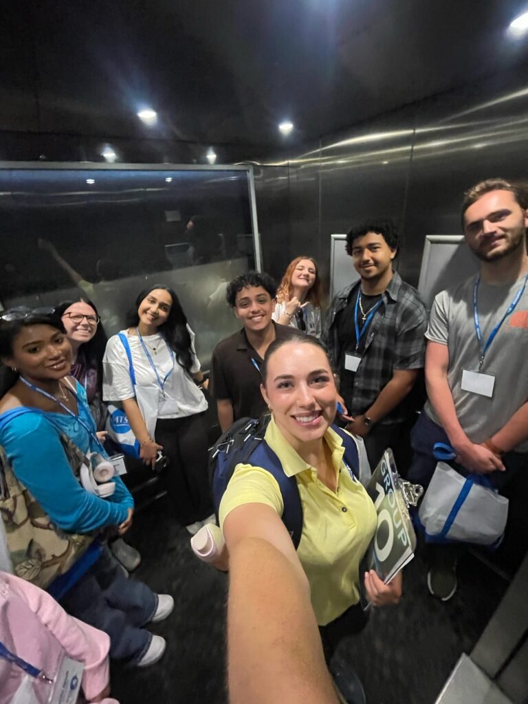 Students attending New to Blue Orientation posing for a photo in an elevator with their Student Orientation Assistant.
