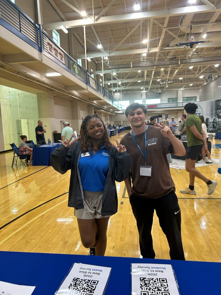 Students attending New to Blue Orientation posing for a photo with their Student Orientation Assistant.