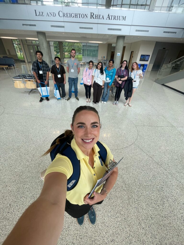 Students attending New to Blue Orientation posing for a photo in the Science Building with their Student Orientation Assistant.