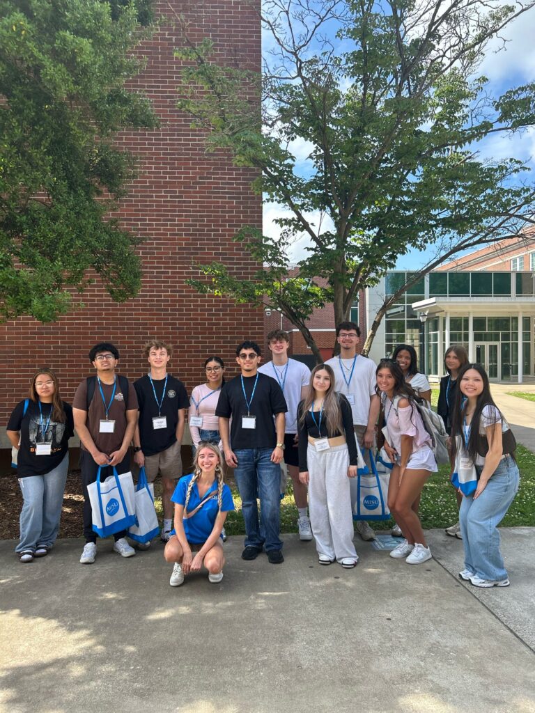 Students attending New to Blue Orientation posing for a photo with their Student Orientation Assistant.