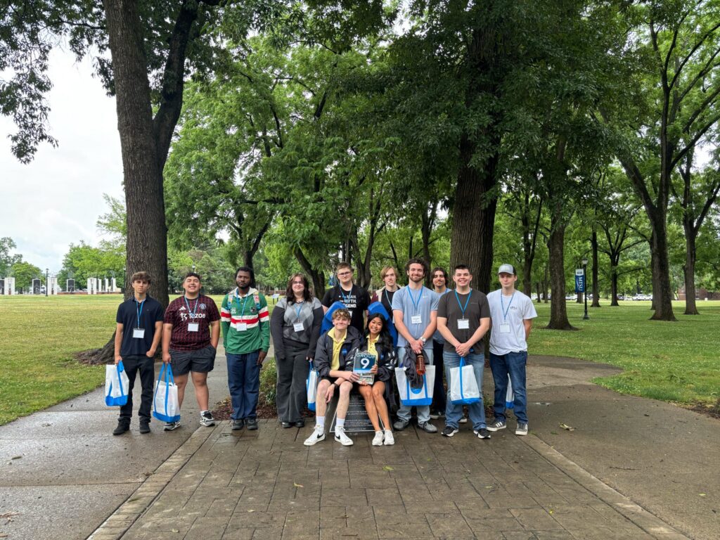 Students in Group 9 of orientation posing for a photo at the blue horseshoe at MTSU with their Student Orientation Assistants.