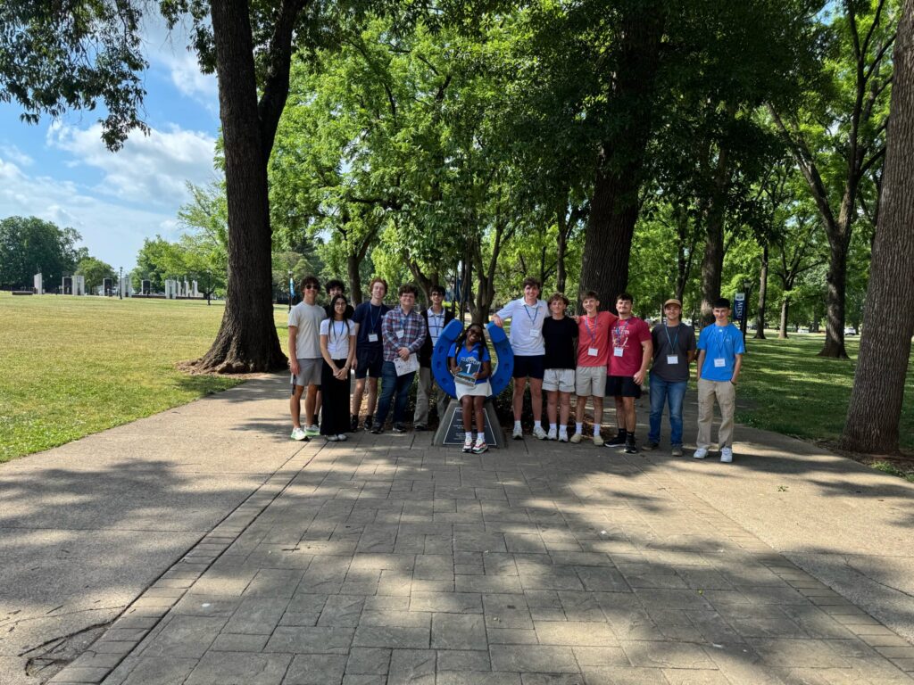 Students in Group 1 of orientation posing for a photo at the blue horseshoe at MTSU with their Student Orientation Assistant.