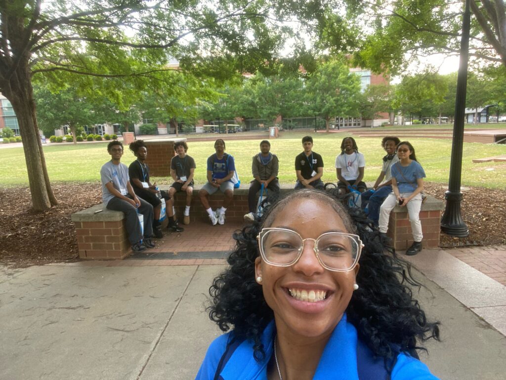 Students attending New to Blue Orientation sitting outside the Student Union with their Student Orientation Assistant.