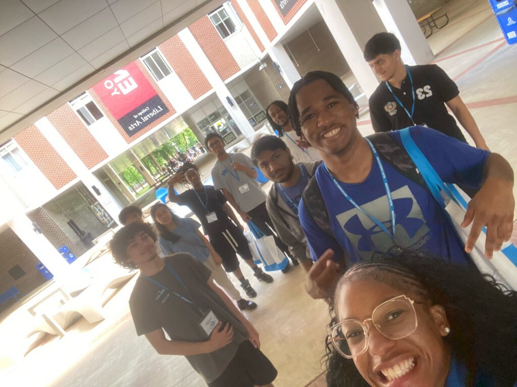 Students attending New to Blue Orientation posing for a photo with their Student Orientation Assistant at Peck Hall.