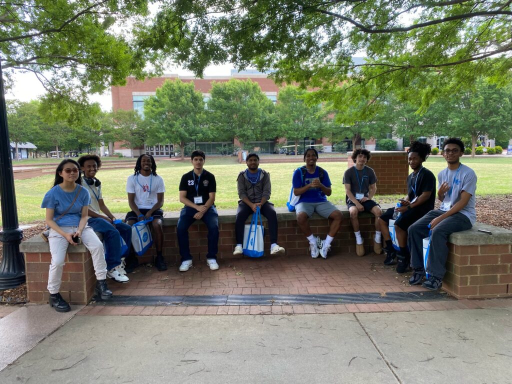 Students attending New to Blue Orientation sitting outside the Student Union.