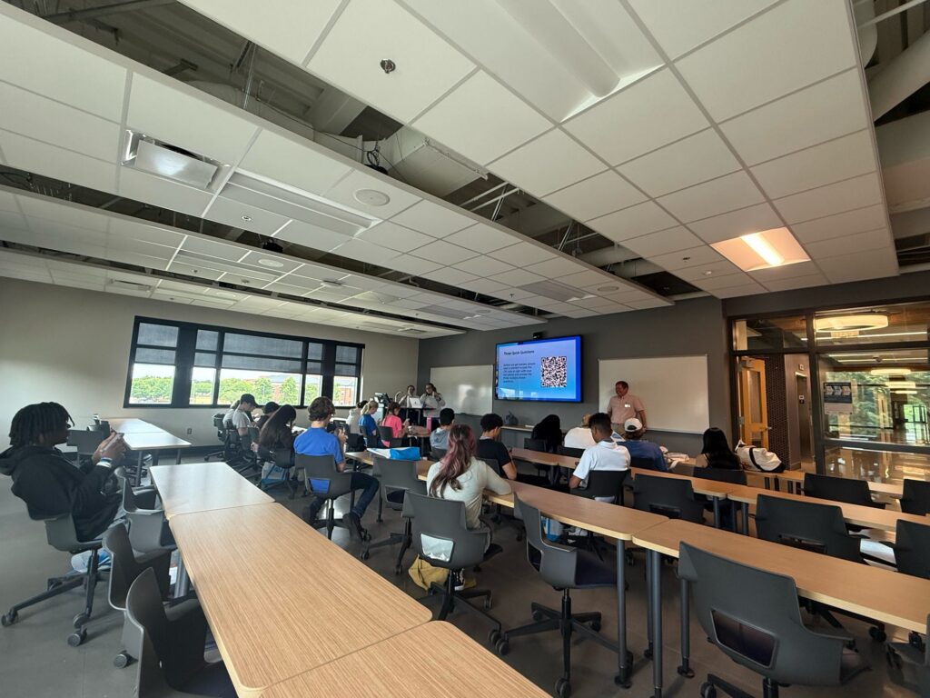 Students attending New to Blue Orientation sitting in a classroom during a presentation.