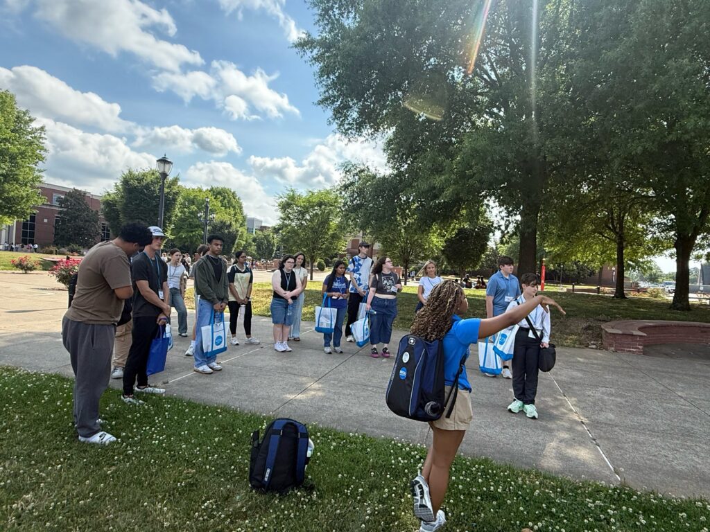 Students attending New to Blue Orientation standing outside with their Student Orientation Assistant.