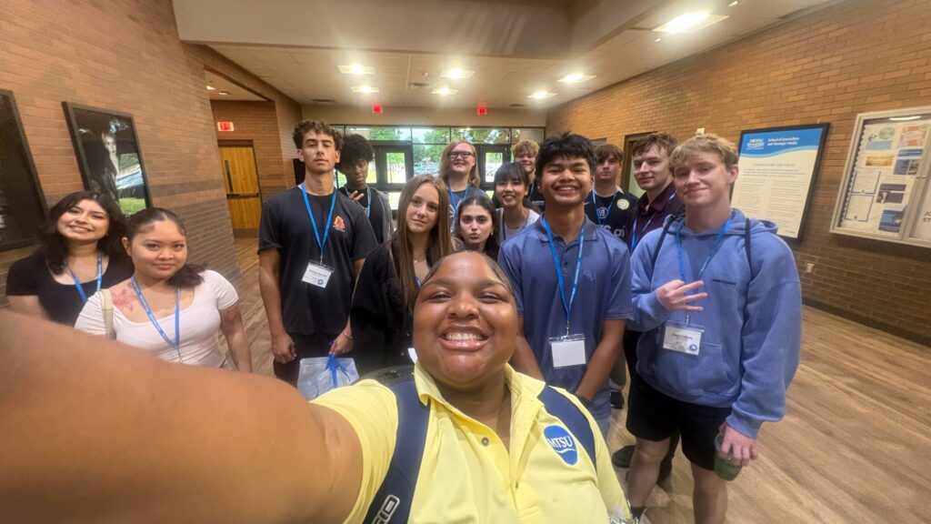 Students attending New to Blue Orientation posing for a photo with their Student Orientation Assistant.