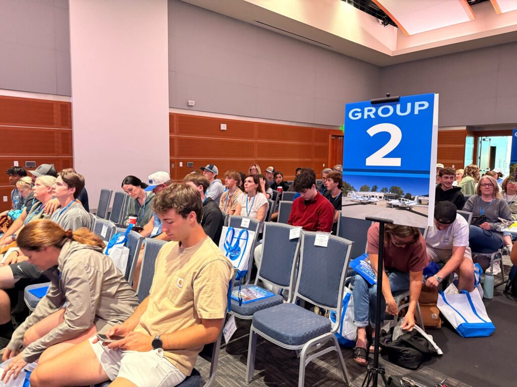 Students and guests attending New to Blue Orientation sitting in the Student Union near the Group 2 sign.
