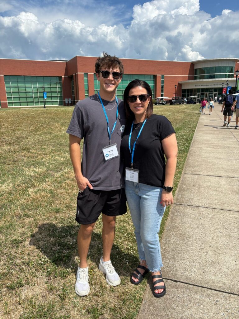 Student and guest attending New to Blue Orientation, posing for a photo outside the Recreation Center.