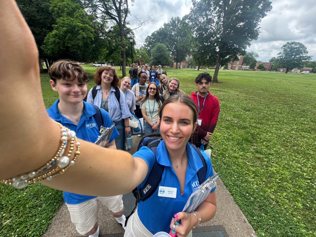 Students in Group 20 of orientation posing for a photo with their Student Orientation Assistants.