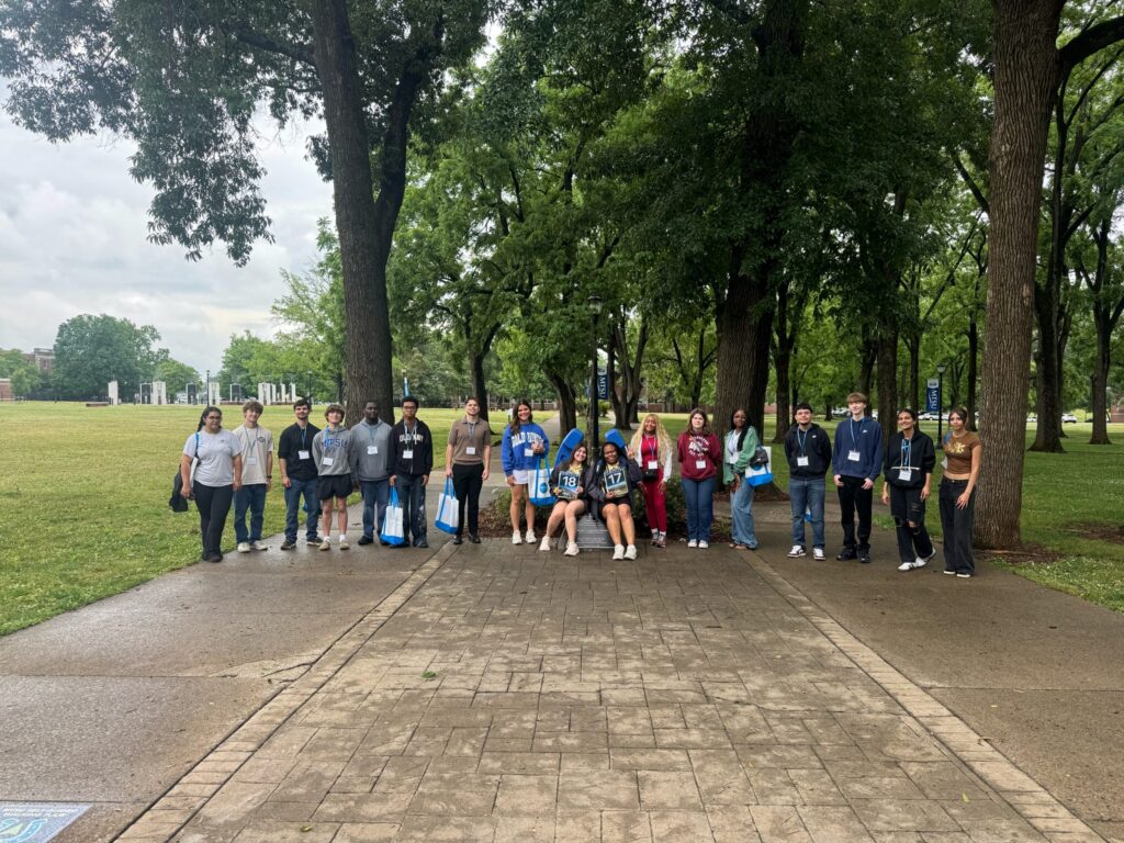 Students in Group 17 and 18 of orientation posing for a photo at the blue horseshoe at MTSU with their Student Orientation Assistants.