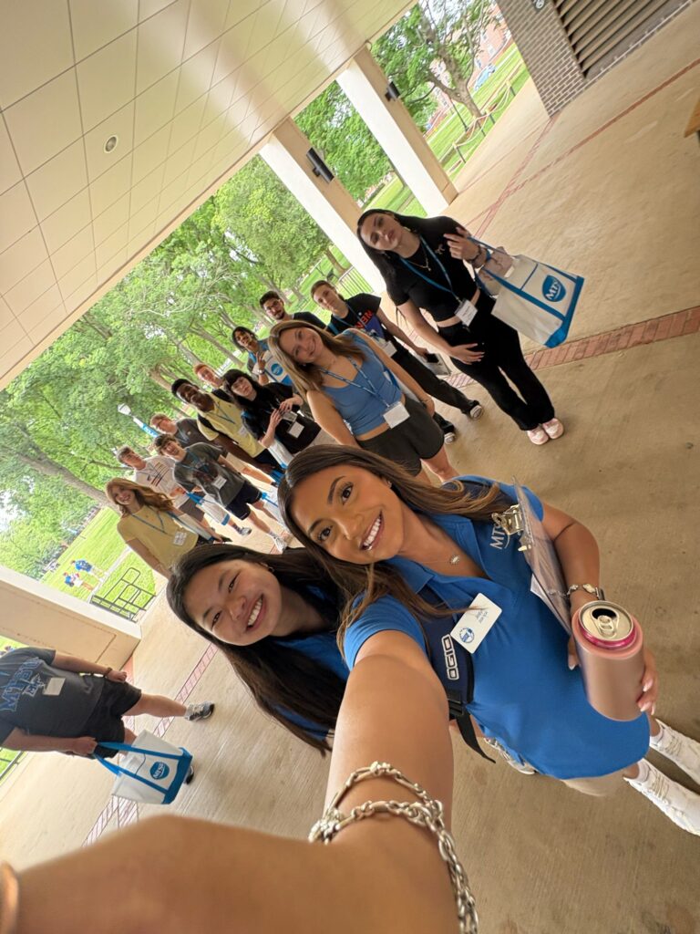 Students attending New to Blue Orientation posing for a photo with their Student Orientation Assistant.