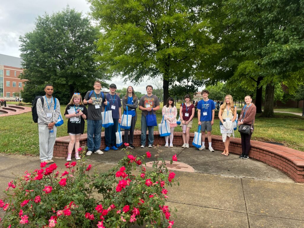 Students attending New to Blue Orientation posing for a photo outside.