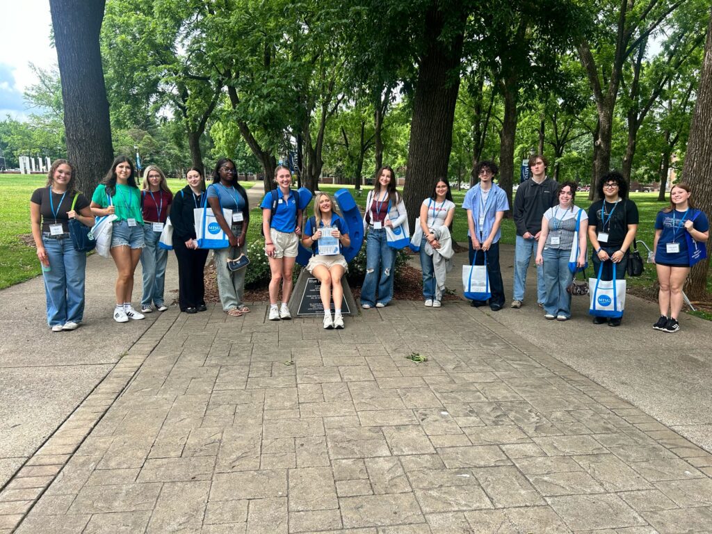 Students attending New to Blue Orientation posing for a photo with their Student Orientation Assistant.