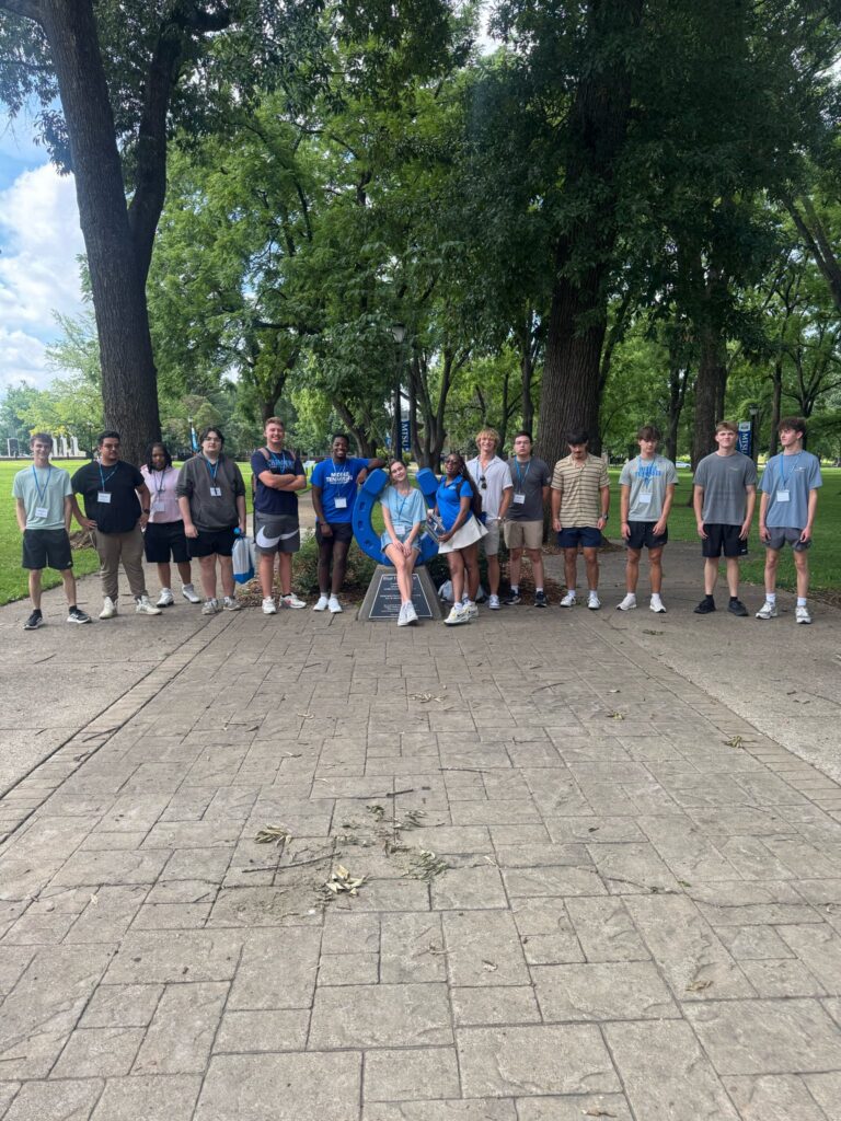 Students attending New to Blue Orientation posing for a photo with their Student Orientation Assistant.