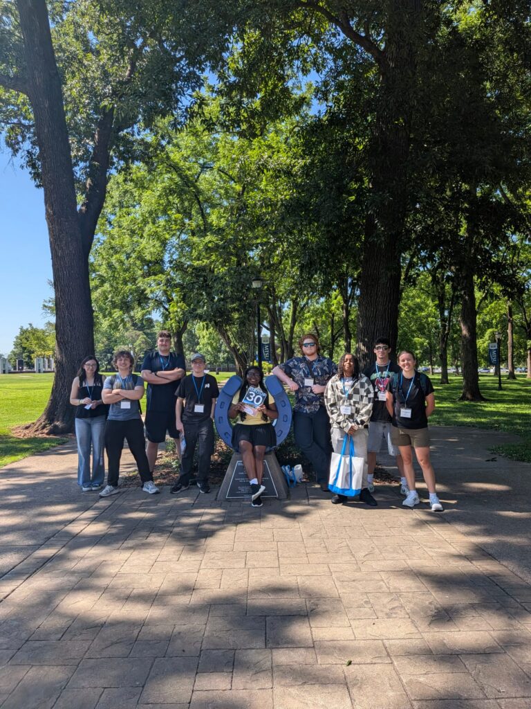 Students in Group 30 of orientation posing for a photo at the blue horseshoe at MTSU with their Student Orientation Assistants.